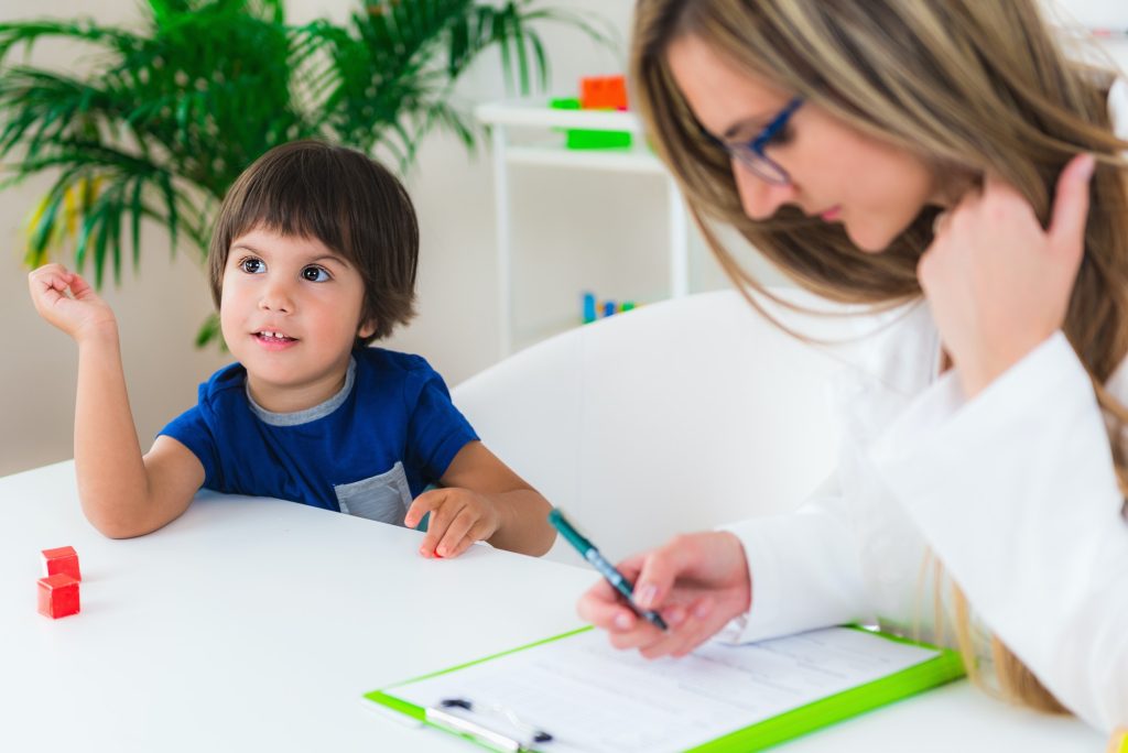 Child psychology, little boy talking to psychologist