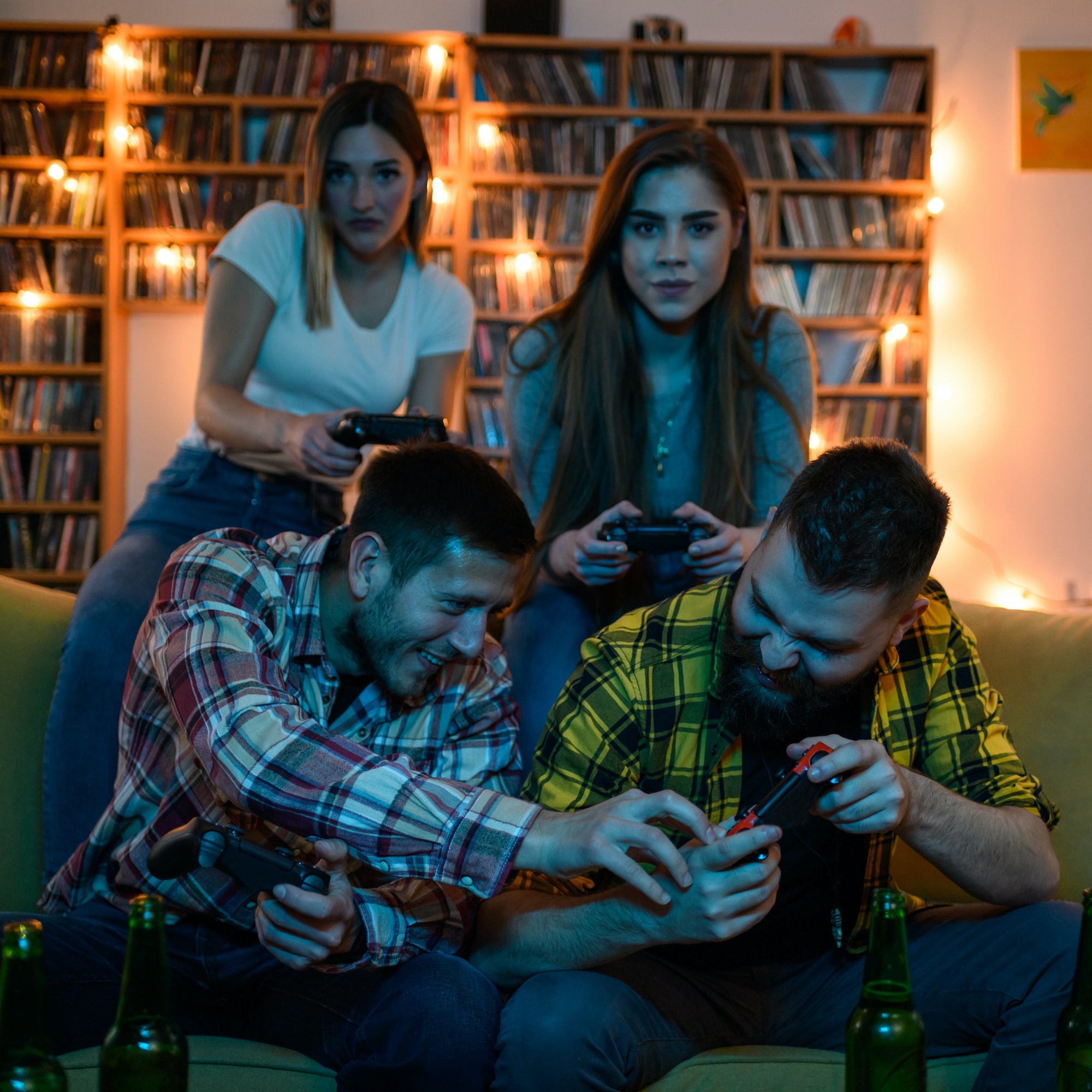 A group of friends playing video games while relaxing at home