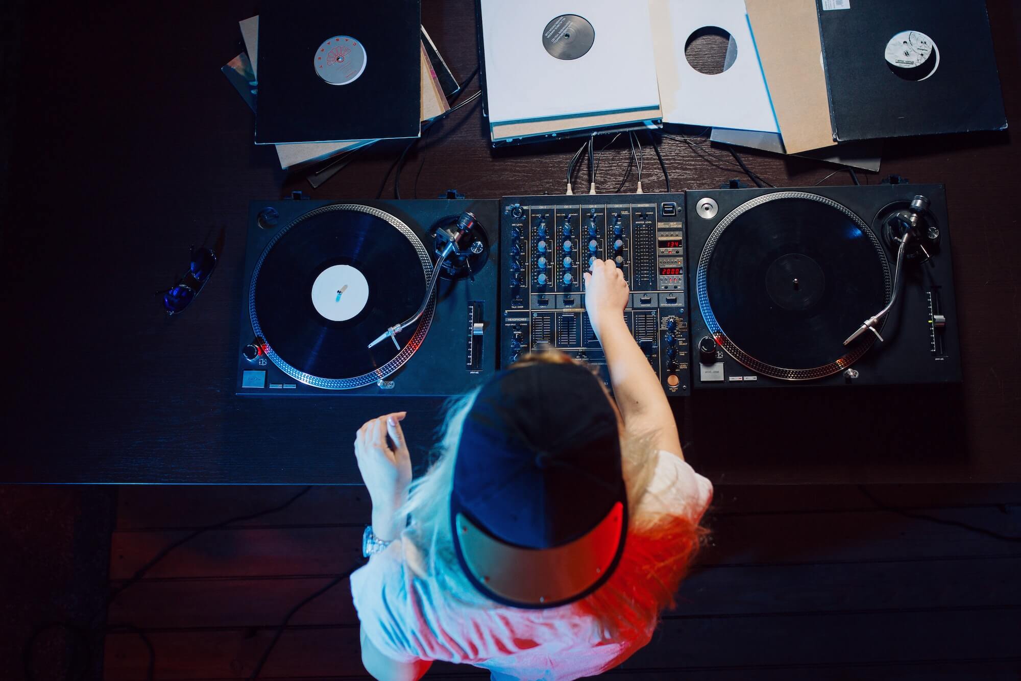 Cute dj woman having fun playing music at club party